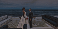 a bride and groom are standing in front of a large body of water