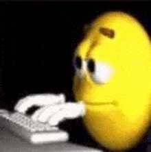 a yellow smiley face is typing on a keyboard in a dark room .