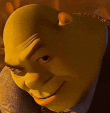 shrek from shrek is wearing a suit and tie and smiling at the camera .