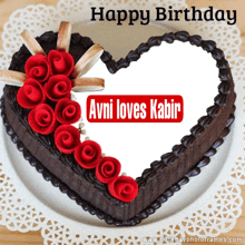 a heart shaped cake with red roses and the name avni on it