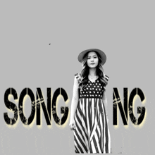 a woman in a striped dress stands in front of the word song