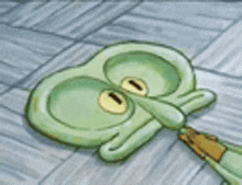 a cartoon squidward from spongebob squarepants is laying on the ground .