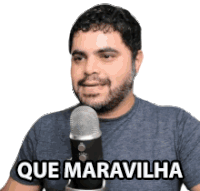 a man with a beard is holding a microphone and says que maravilhosa .