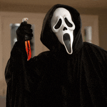 scream holding a bloody knife in his hand