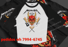 several metallica shirts are stacked on top of each other with metallica hellfire club written on the front