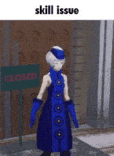 a girl in a blue dress standing in front of a closed sign