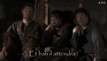 three men are sitting next to each other and the words " et bah il attendra " are on the screen