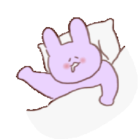 a purple bunny is laying on a bed with a pillow and blanket .