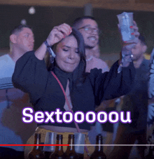 a woman in a black top is holding a drink in her hand with the words sextoooou written on the bottom