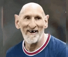 a bald man with a beard and big ears is wearing a blue jersey .