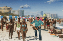 a man holding a chainsaw is walking on a beach