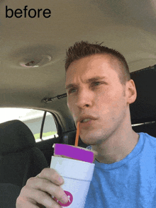 a man in a car drinking from a cup with a purple lid and a straw