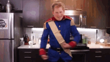 a man in a blue and red uniform is dancing in a kitchen with a sticker on the refrigerator that says healthy food