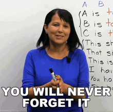 a woman holding a marker in front of a white board with the words " you will never forget it "