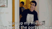 a man is standing in front of a door with the words " wassup my friends the life of the party is here "