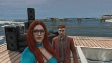 a man and a woman are standing on a dock in front of a stack of speakers