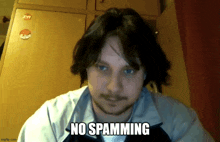 a man with a beard says no spamming in front of his face