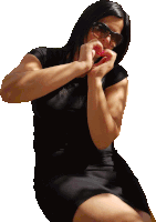 a woman wearing sunglasses and a black dress is making a heart with her hands