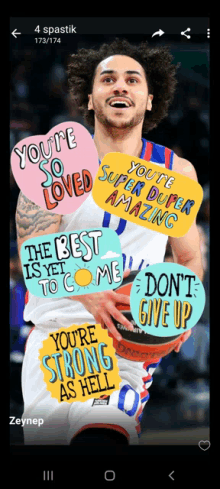 a basketball player is holding a basketball with stickers on his shirt that say you 're so loved