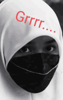 a woman wearing a white hijab and a black mask has the word grrr written on her head