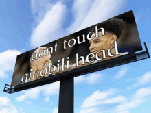 a billboard says " dont touch qinobili head " on it