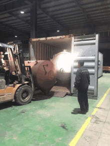 a man standing in front of a container that says doosan