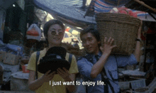 a man carrying a basket and a woman holding a hat with the words i just want to enjoy life written below