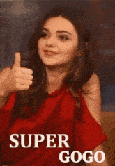 a woman in a red dress is giving a thumbs up and the words `` super gogo '' behind her .