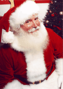 a man dressed as santa claus with a white beard and glasses