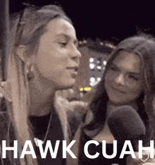 two women are talking to each other and the words hawk cuah are visible