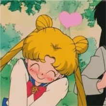 sailor moon is smiling and hugging a man with a heart on her head .