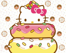 hello kitty is sitting on a stack of donuts with sprinkles on them