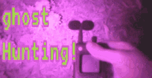 a person is holding a camera in front of a sign that says ghost hunting !