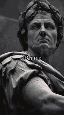 a statue of a man with a laurel wreath on his head and the words " i came " below it