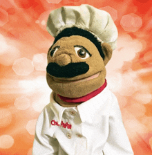 a puppet with a chef 's hat and a chef 's coat that says chef peepee