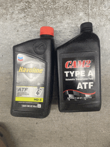 a bottle of havoline and a bottle of cam2 type a automatic transmission fluid