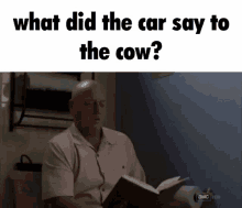 a man is reading a book in a bathroom while asking what did the car say to the cow