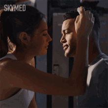 a woman touching a man 's forehead with the word skymed on the bottom right