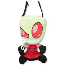 a stuffed toy of a green alien with red eyes and a red dress