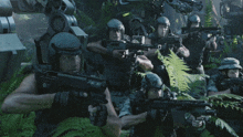 a group of soldiers are holding guns in a jungle and one of them has the letter o on his helmet