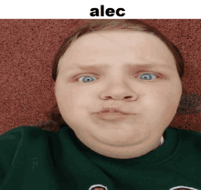 a girl with blue eyes is making a funny face and the name alec is on the bottom