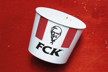 a paper cup with a kfc logo on it on a red background