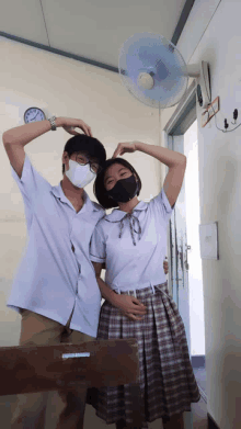 a boy and a girl wearing masks pose for a photo