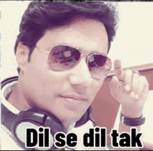 a man wearing sunglasses and headphones with the words dil se dil tak written below him