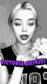 a black and white photo of a girl with the name victoria quinzel on her chest .