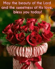 a bouquet of red roses in a basket with candy canes