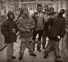 a black and white photo of a group of people standing on a sidewalk