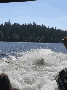 a person on a boat looking out over a lake