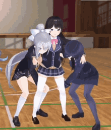 three anime girls are hugging each other on a wooden floor