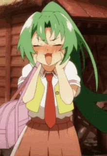 a girl with green hair and a red tie is making a face .